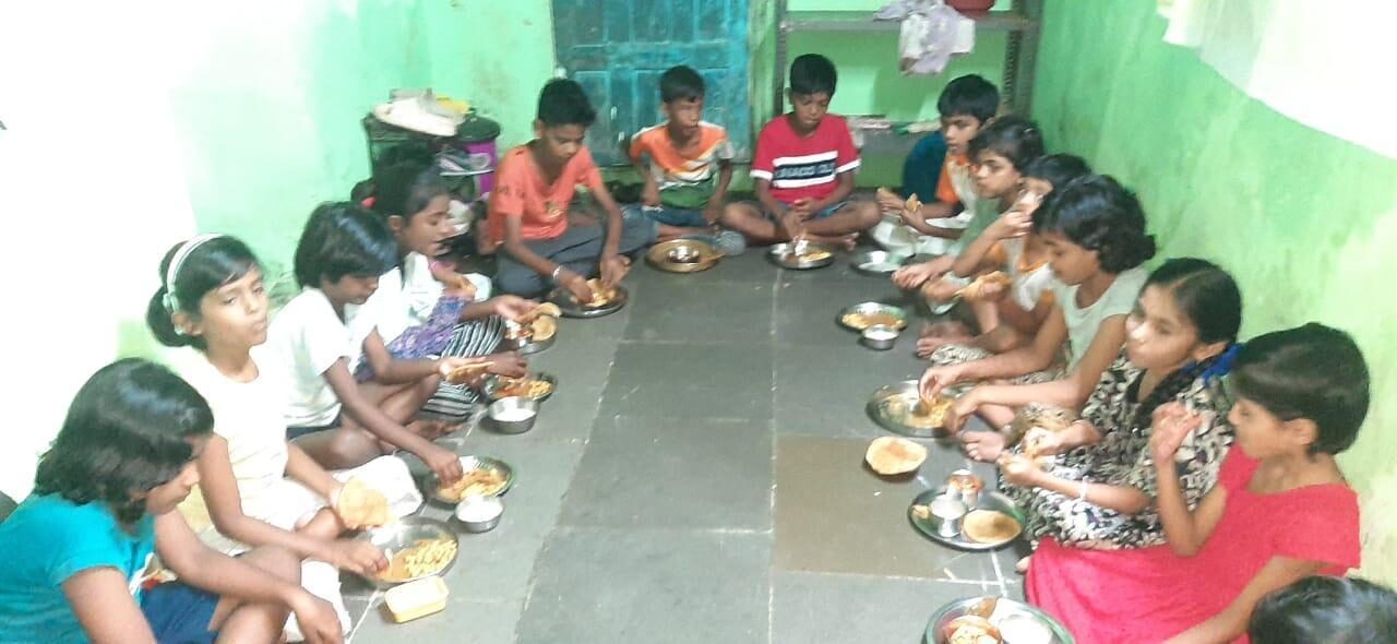 Children receiving a nutritious meal during a Dira Foundation food distribution drive