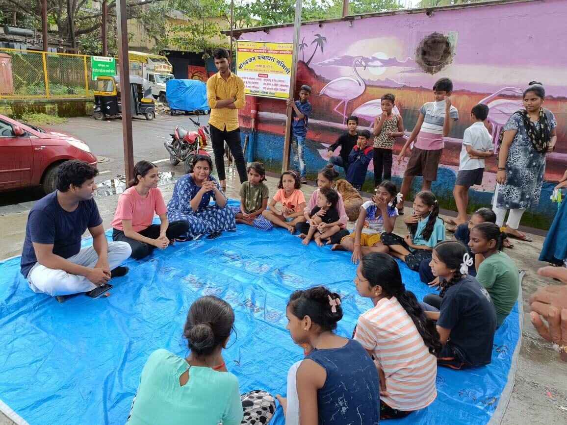 Children and volunteers seated together during a Dira Foundation community workshop